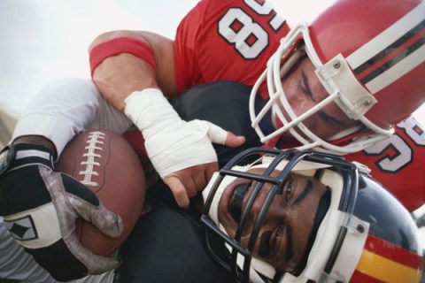 Football players in tackle